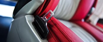 a seatbelt buckle fit into the side of a bus seat