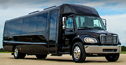 a plain black minibus parked on pavement